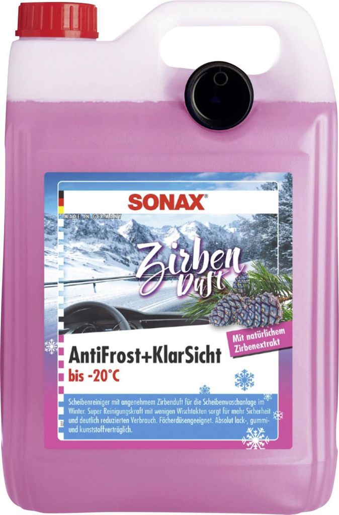 A large plastic container of pink liquid with a label showing a winter scene and product information.
