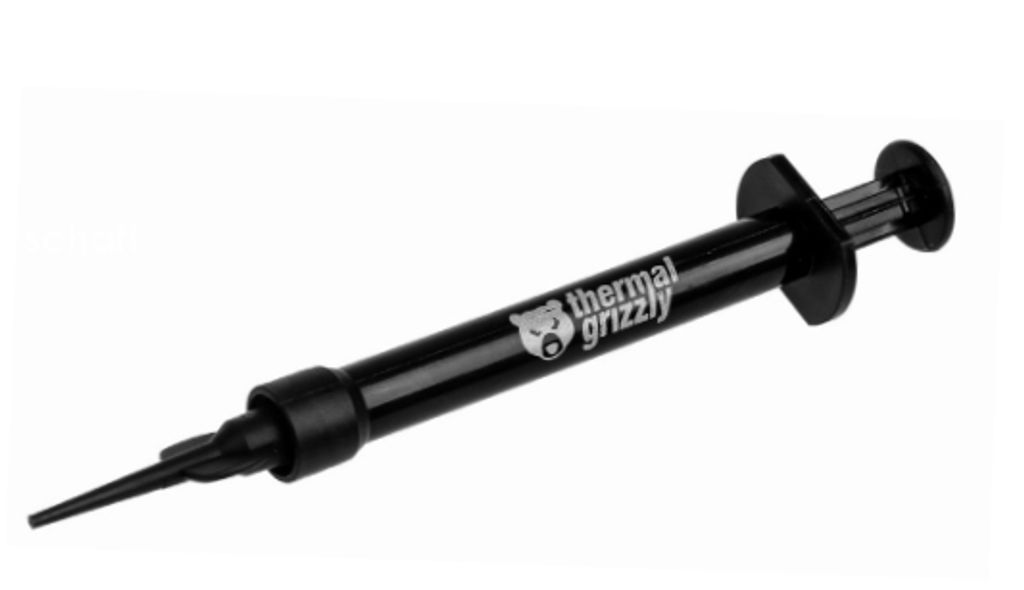 A black syringe of thermal paste on a white background.
