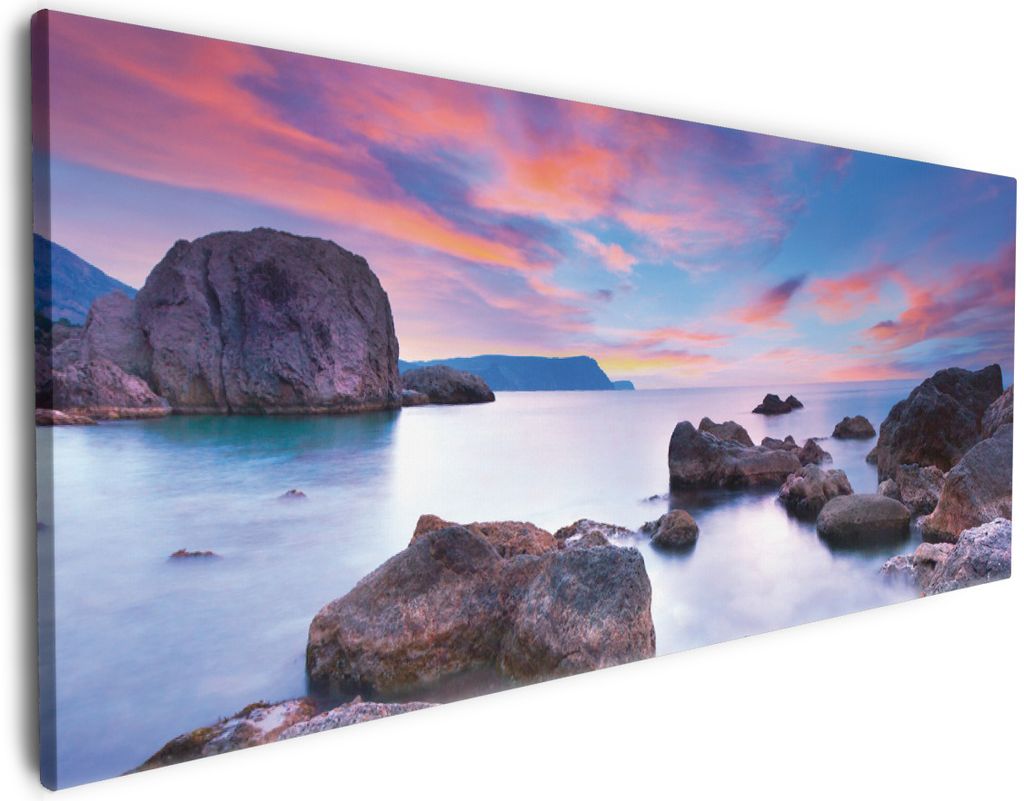 Wallario Premium Leinwandbild Seelandschaft in blau und rot mit großen Felsen in Größe 80 x 200 cm