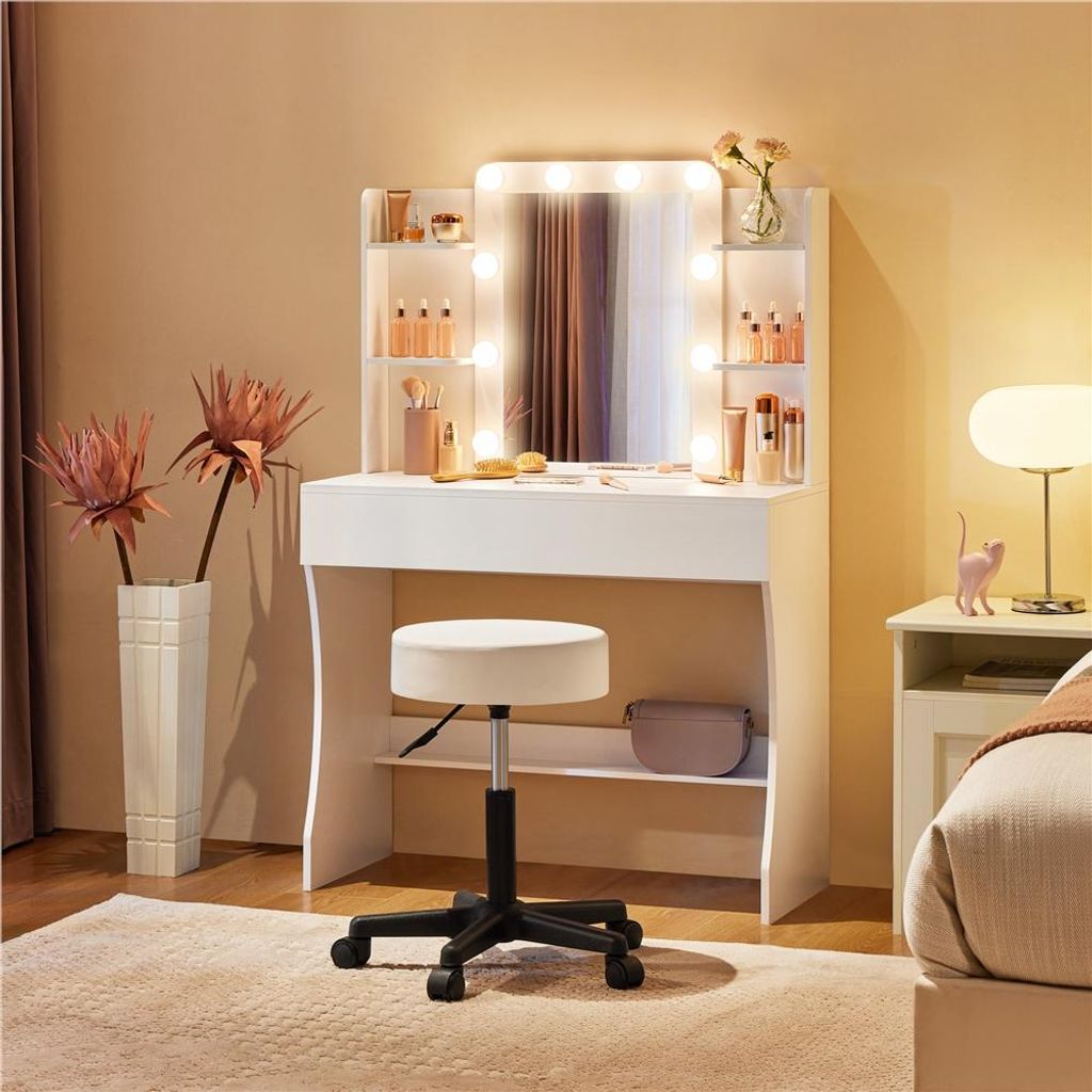 A white vanity table with a mirror and LED lights, a stool, and decorative items in a bedroom setting.