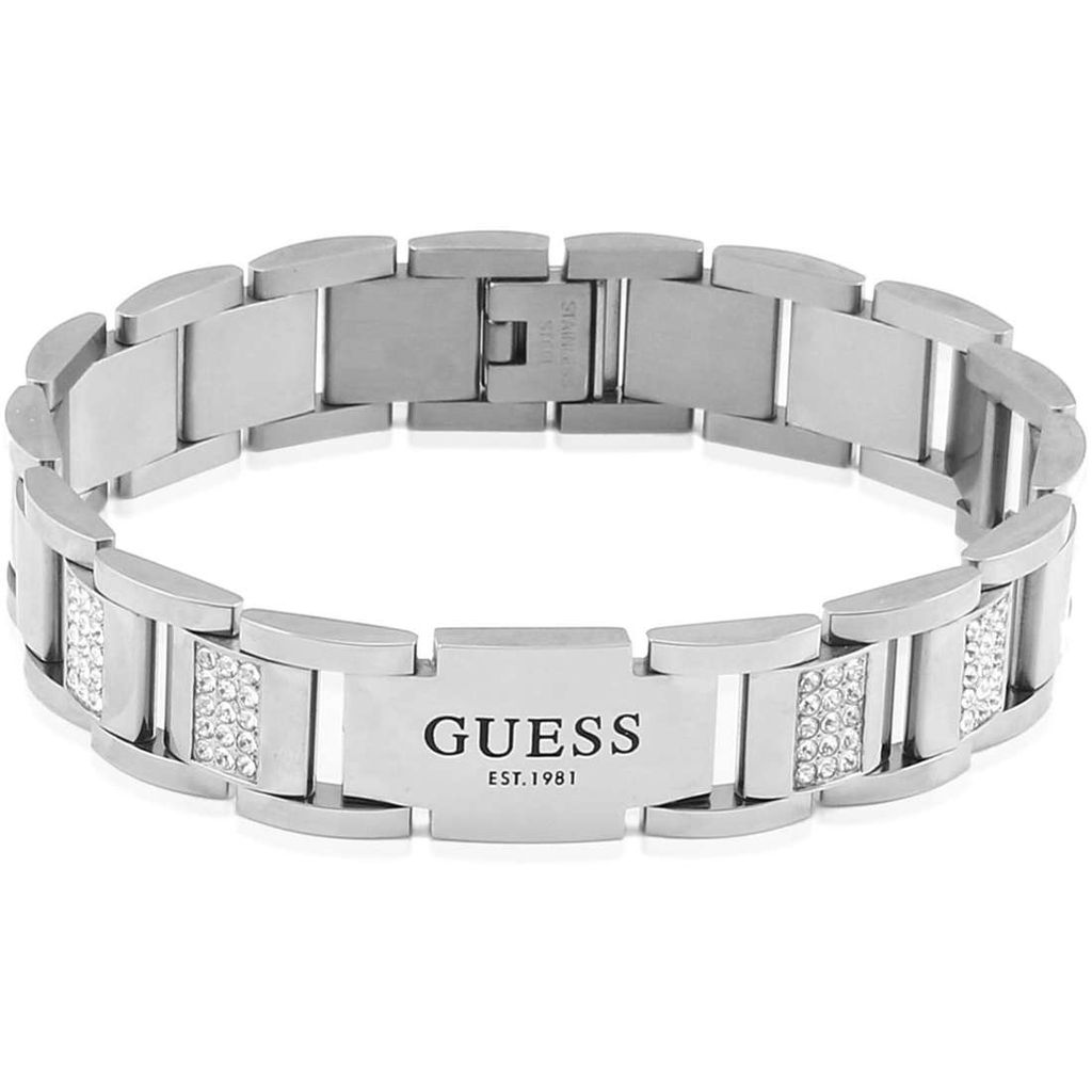 A close-up studio shot of a silver-colored Guess bracelet.