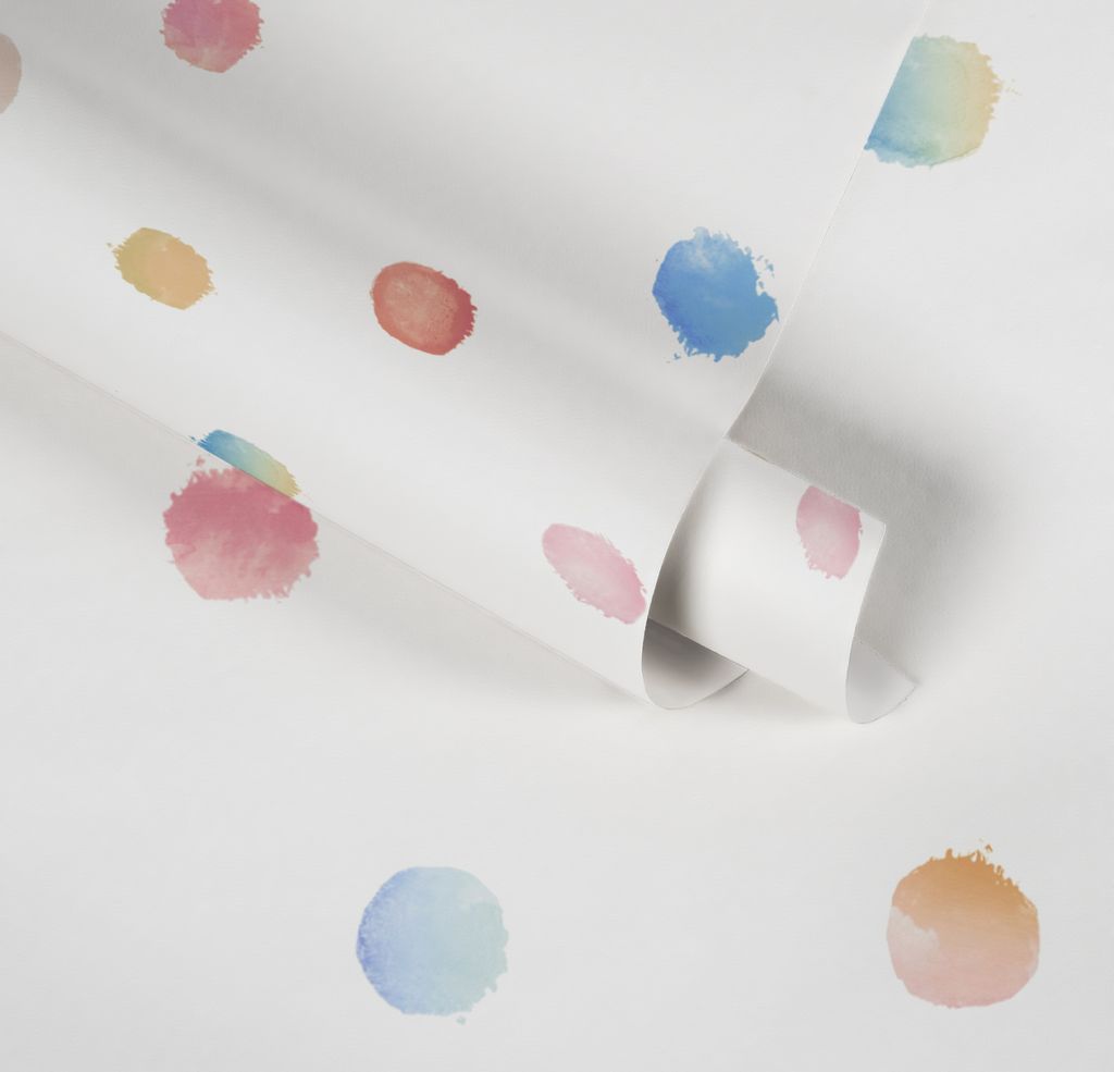 A roll of white wallpaper with colorful watercolor-like polka dots.