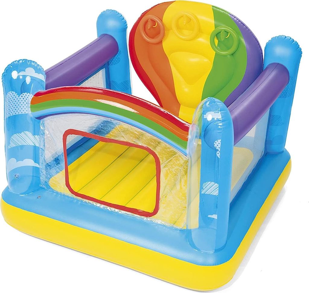 An inflatable bouncy castle with a rainbow and hot air balloon theme.