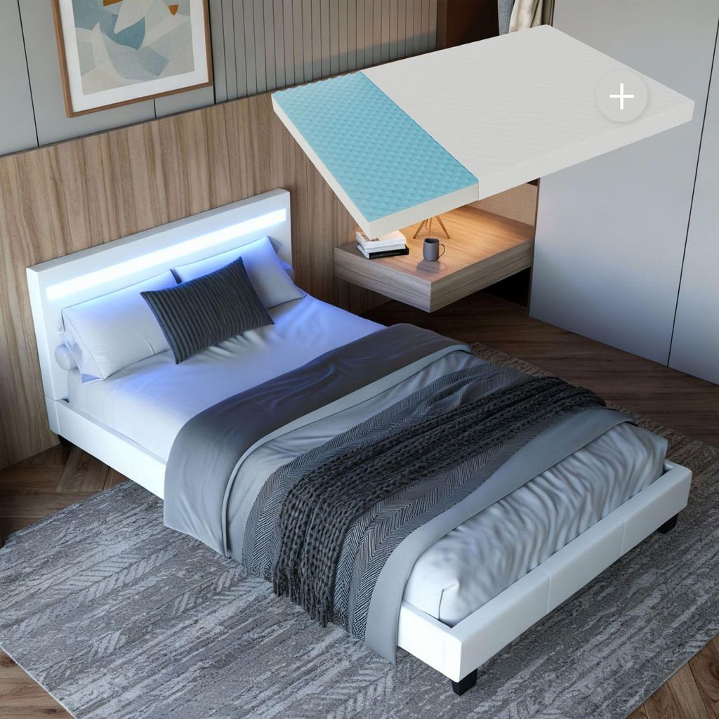 A modern bedroom with a white LED bed and a mattress overlay.