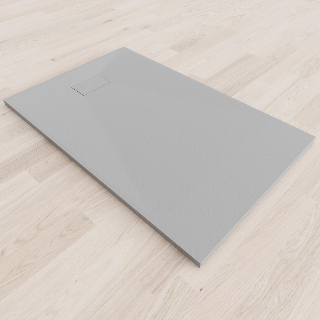 A grey shower tray on a light wood floor.