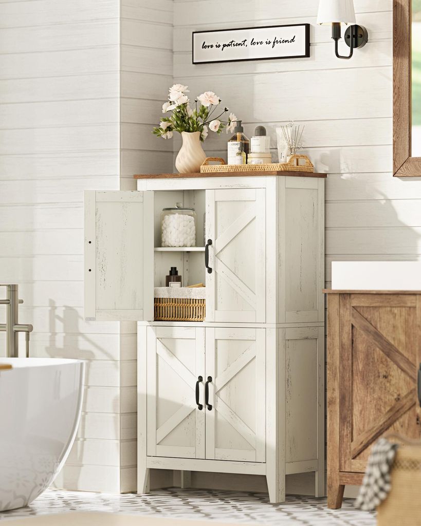 A bathroom with a white cabinet, bathtub, and wooden vanity.