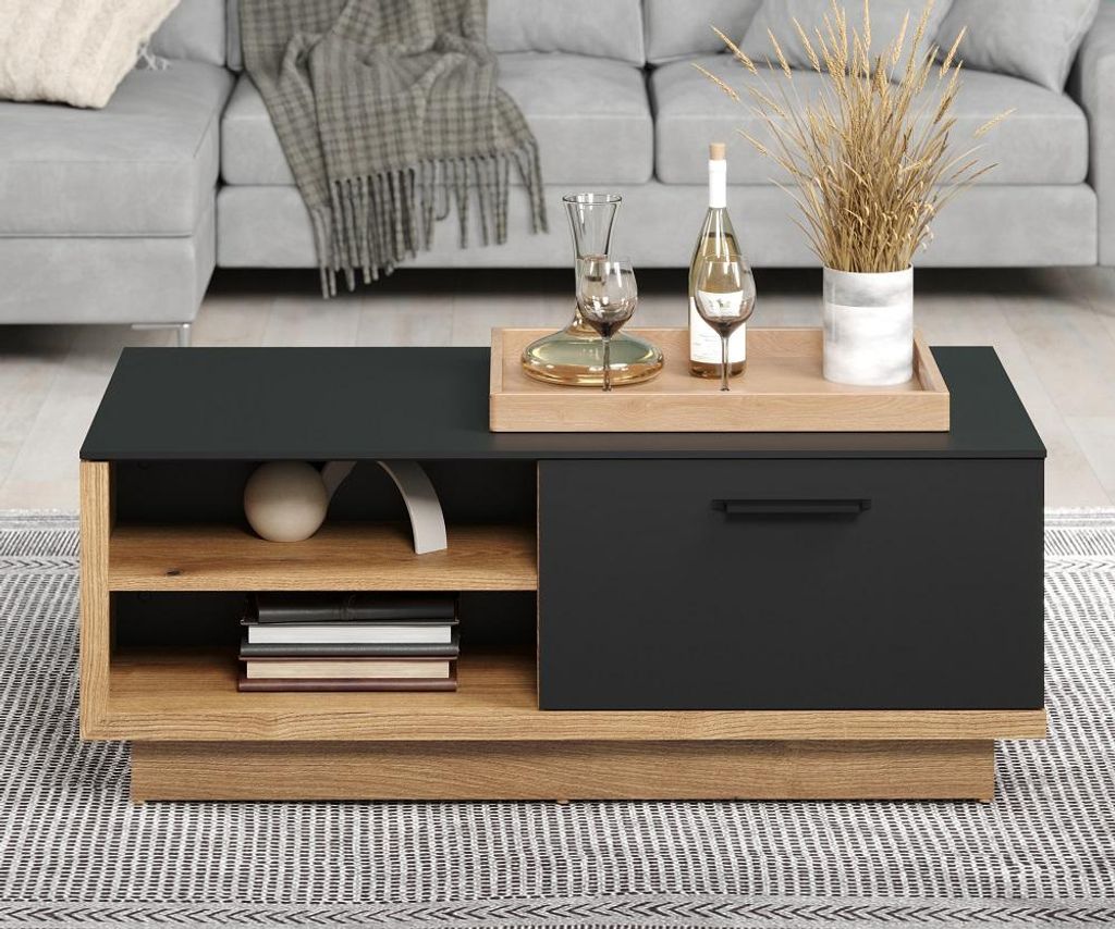 A modern coffee table with storage, placed in a living room setting with a sofa in the background.