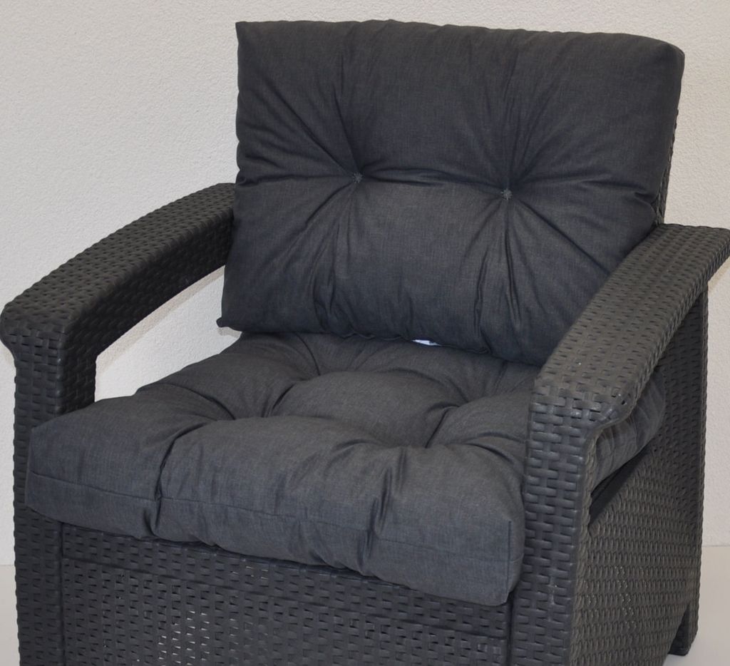 A close-up view of a dark gray cushion set for PE rattan furniture, placed on the furniture itself.