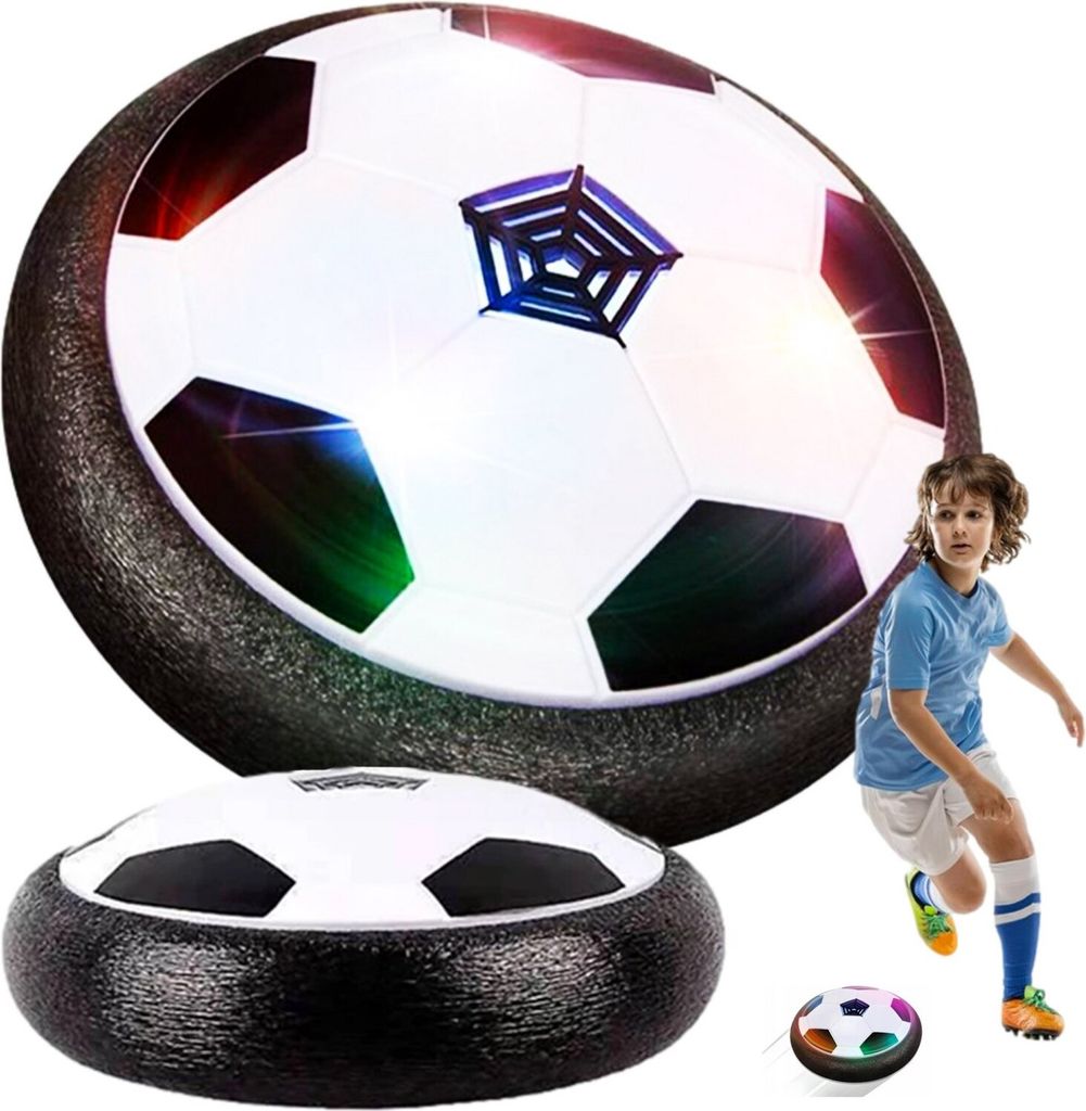 A boy playing with a hover soccer ball, with a larger hover soccer ball in the background.