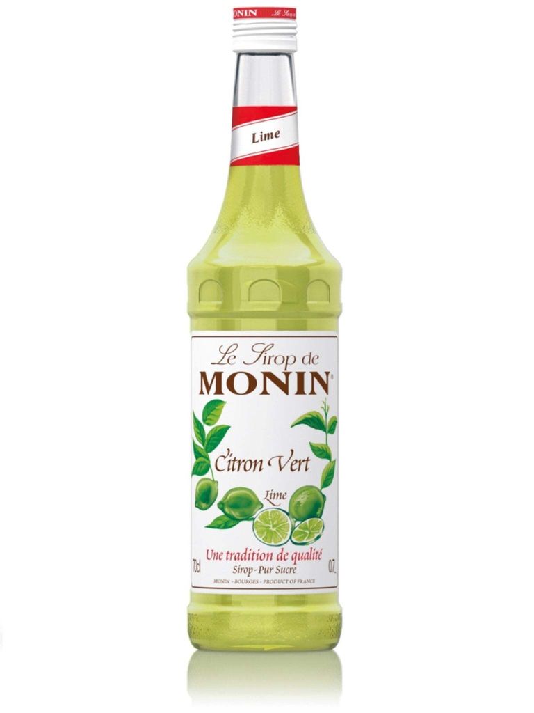 A bottle of Monin Lime syrup against a white background.