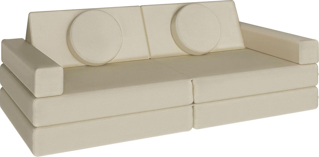 A cream-colored modular sofa with two round accent pillows.