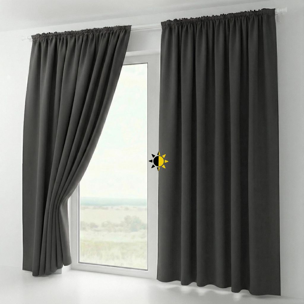 A pair of dark gray blackout curtains hanging on a window.