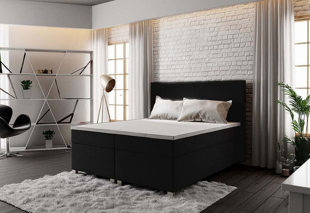 A bedroom scene with a bed, shelving unit, and chair.