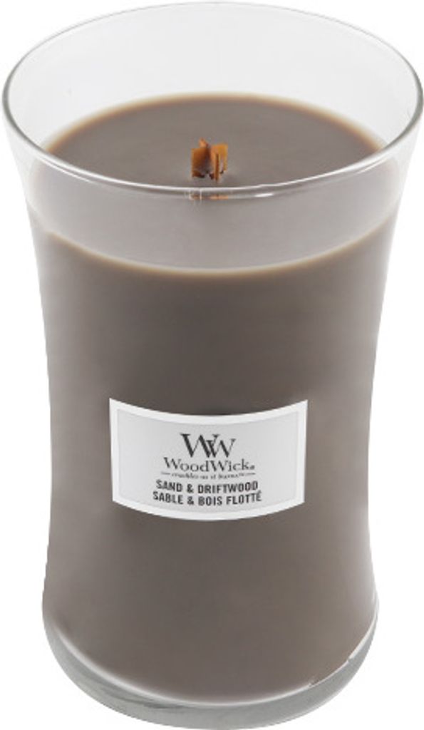 A close-up studio shot of a Woodwick Sand & Driftwood scented candle in a clear glass jar.