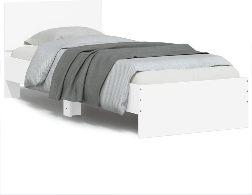 A white bed frame with a mattress and gray bedding, shown from a side angle against a white background.