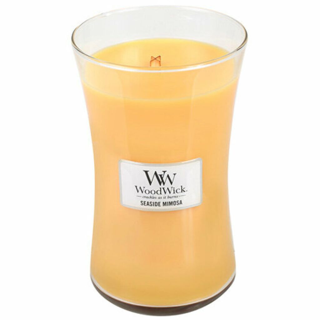 A WoodWick Seaside Mimosa scented candle in a glass jar.