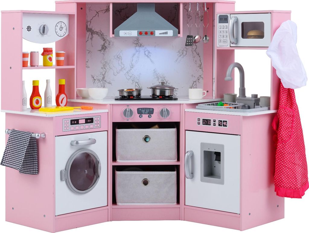 A pink wooden toy kitchen with various accessories.