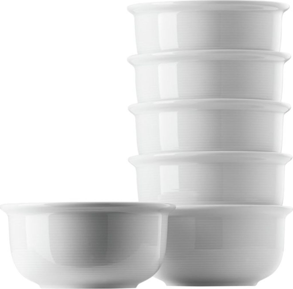 A stack of white dessert bowls and one bowl in front.