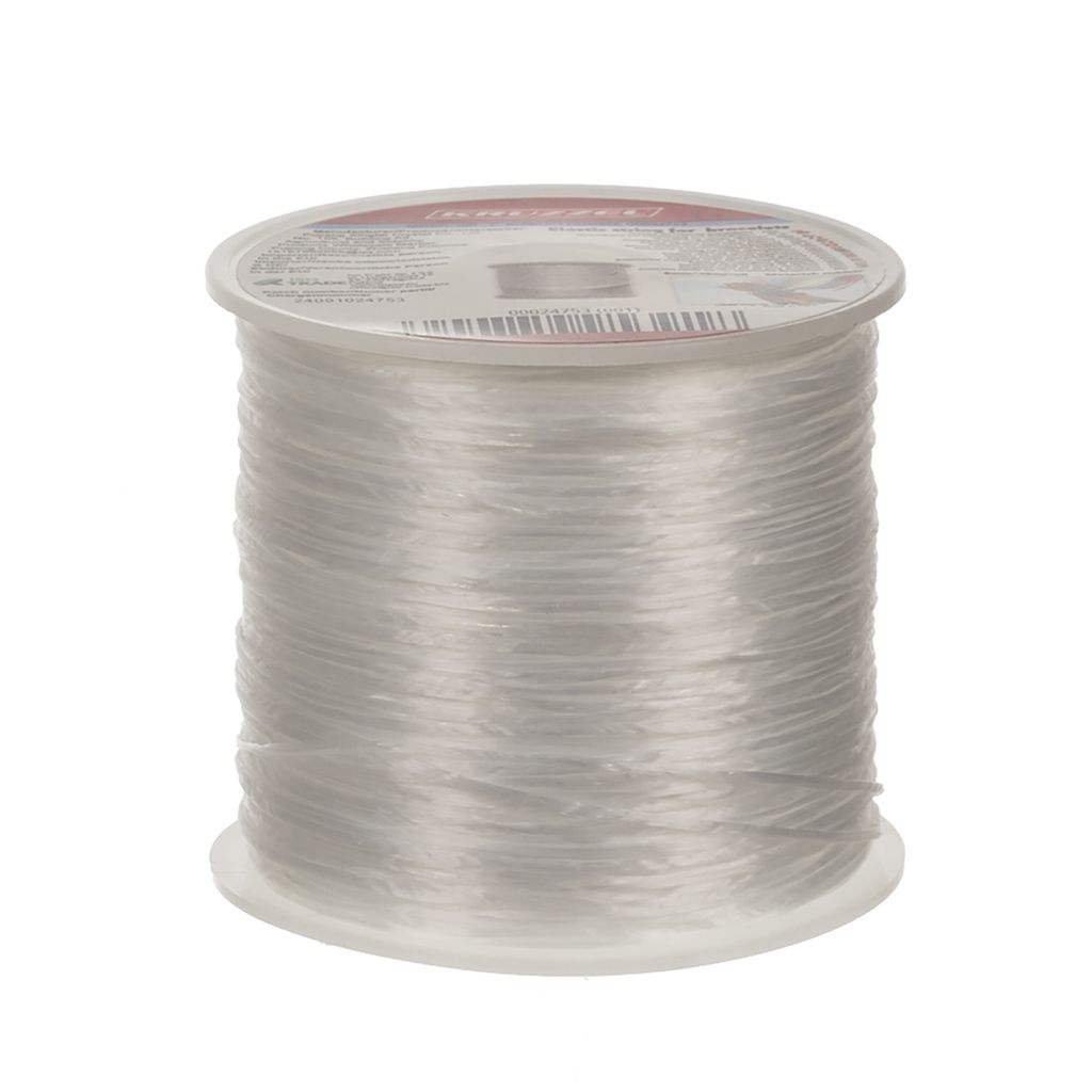 A spool of clear elastic cord on a white background.