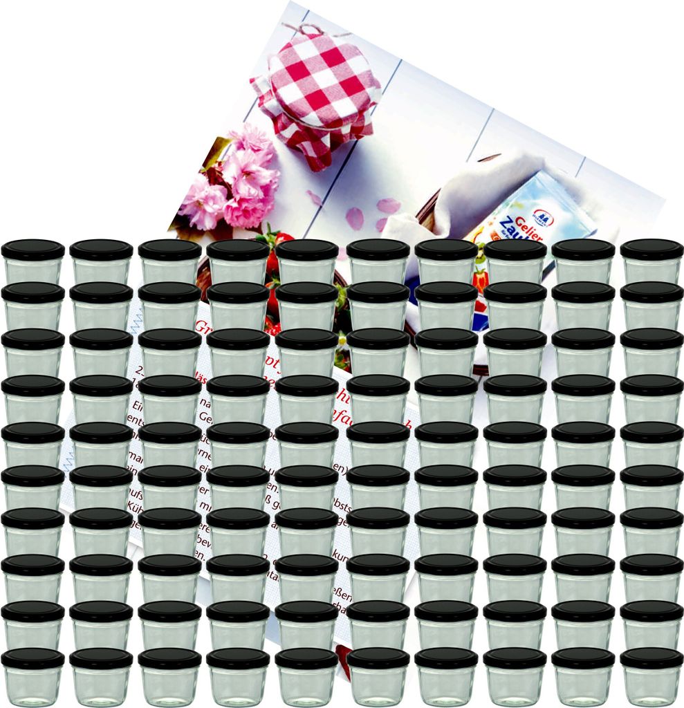 A collection of small glass jars with black lids, arranged in rows, with a decorative checkered lid and flowers in the background.