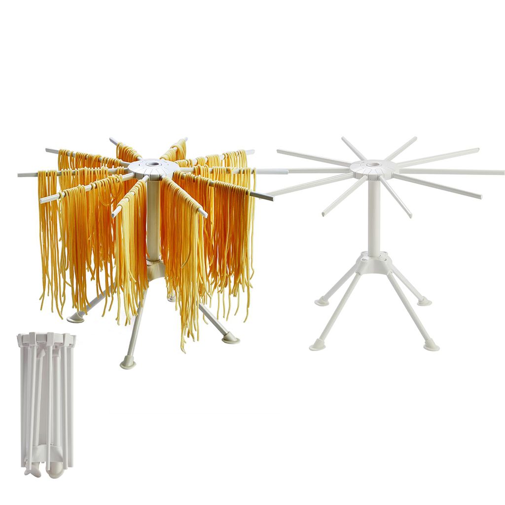 A white pasta drying rack with fresh pasta hanging from it, and another empty pasta drying rack, and a folded pasta drying rack.
