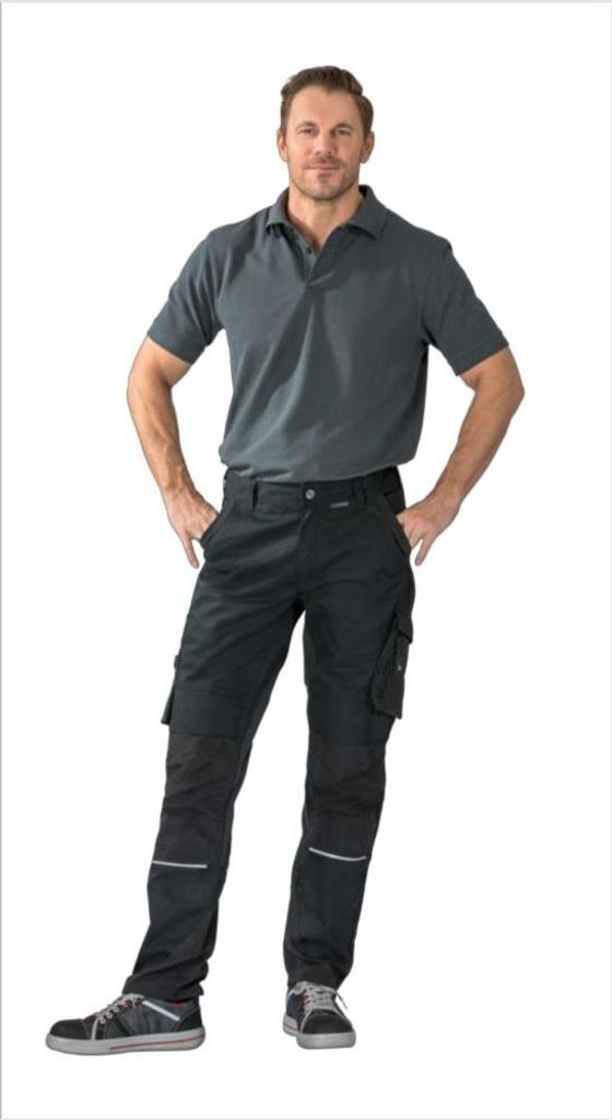 A man wearing black work pants and a gray polo shirt, posing with his hands on his hips.
