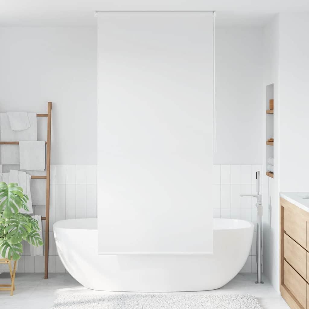 A minimalist bathroom with a freestanding bathtub and a wooden ladder rack with towels.