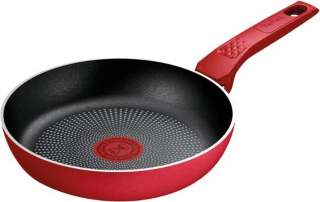 A red frying pan with a black interior and a red handle, shown against a white background.