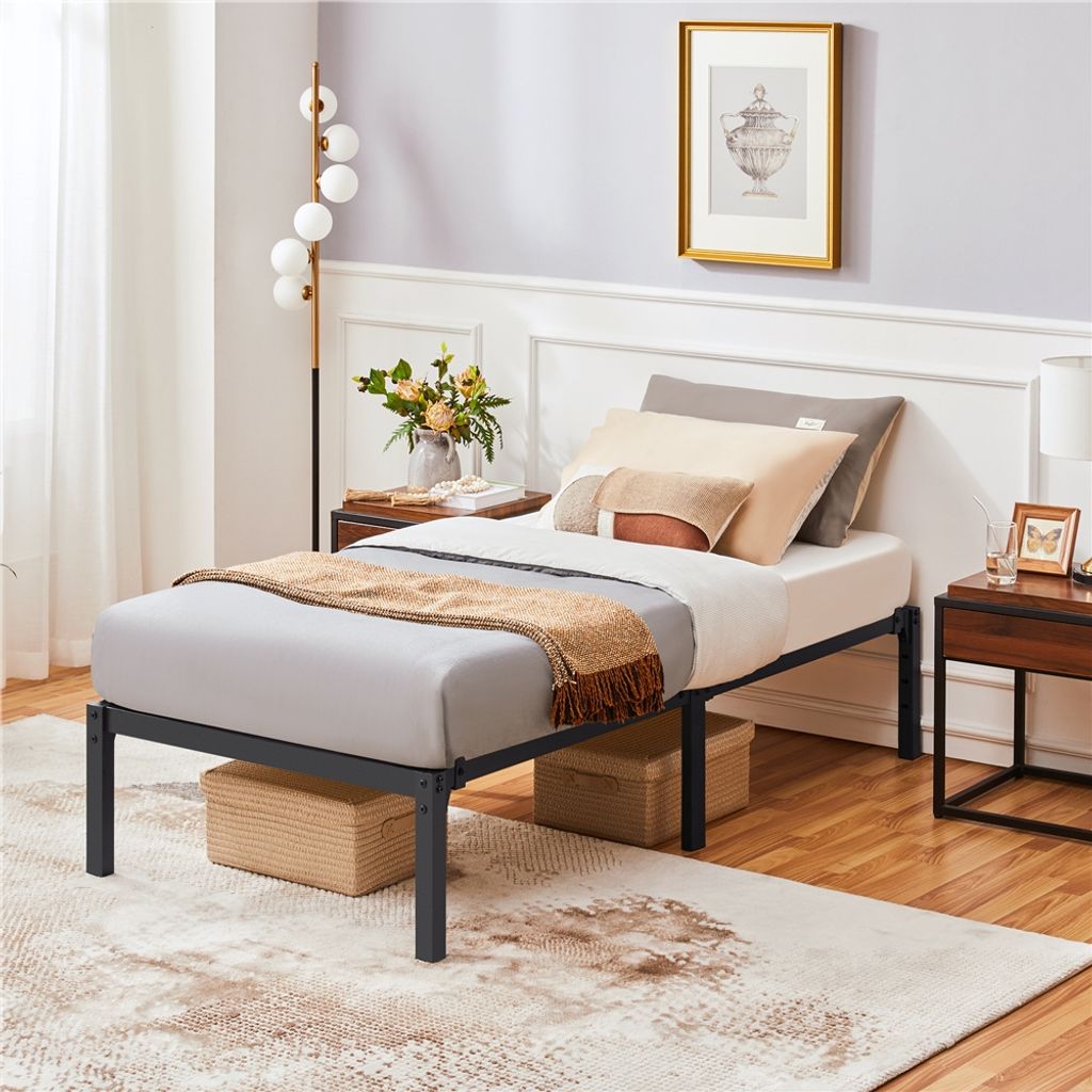 A bedroom scene featuring a single bed with bedding and decorative items.