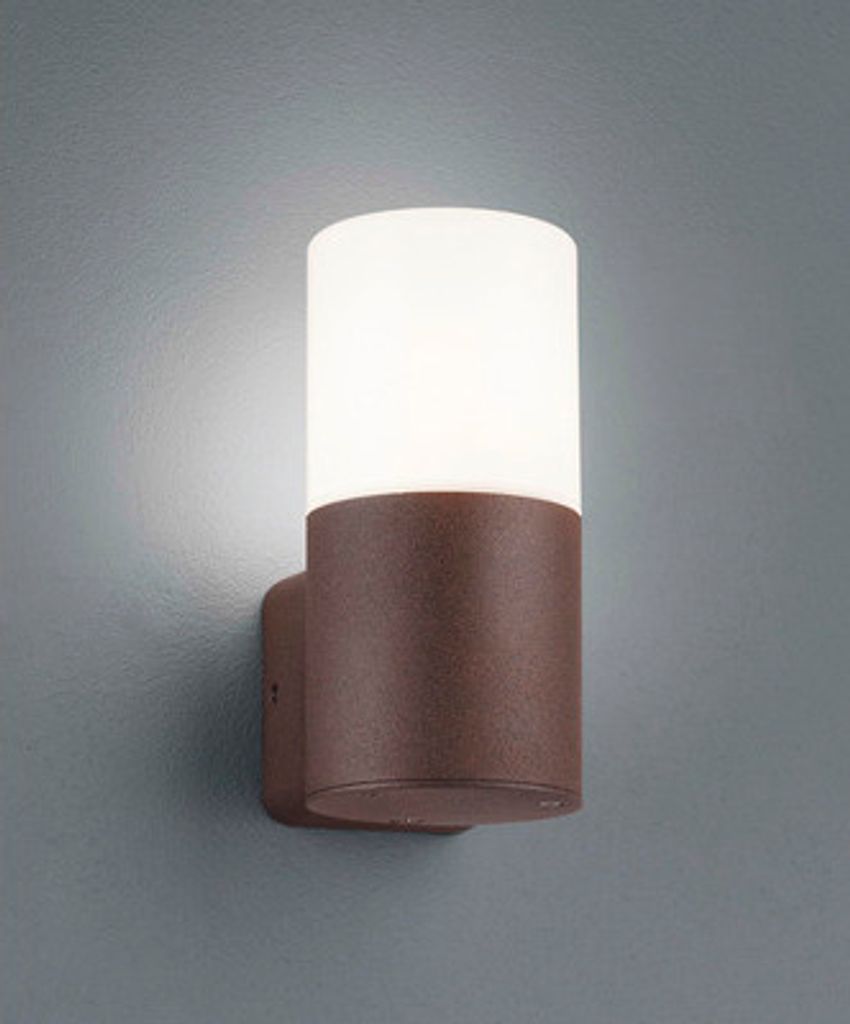 A modern outdoor wall light with a cylindrical frosted white shade and a textured brown base, mounted on a gray wall.