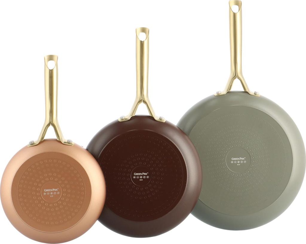Three frying pans of different sizes and colors are shown from the bottom with their handles pointing upwards.