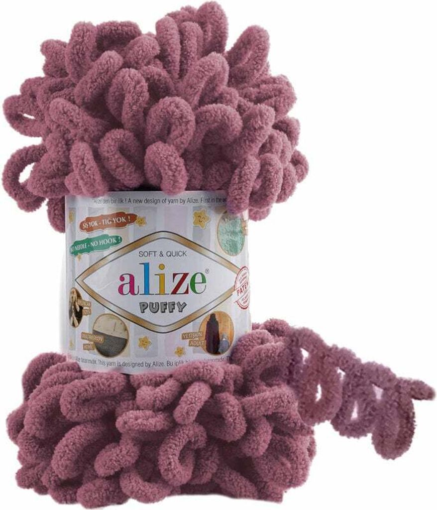 A ball of pink yarn with loops, with a label on the side.
