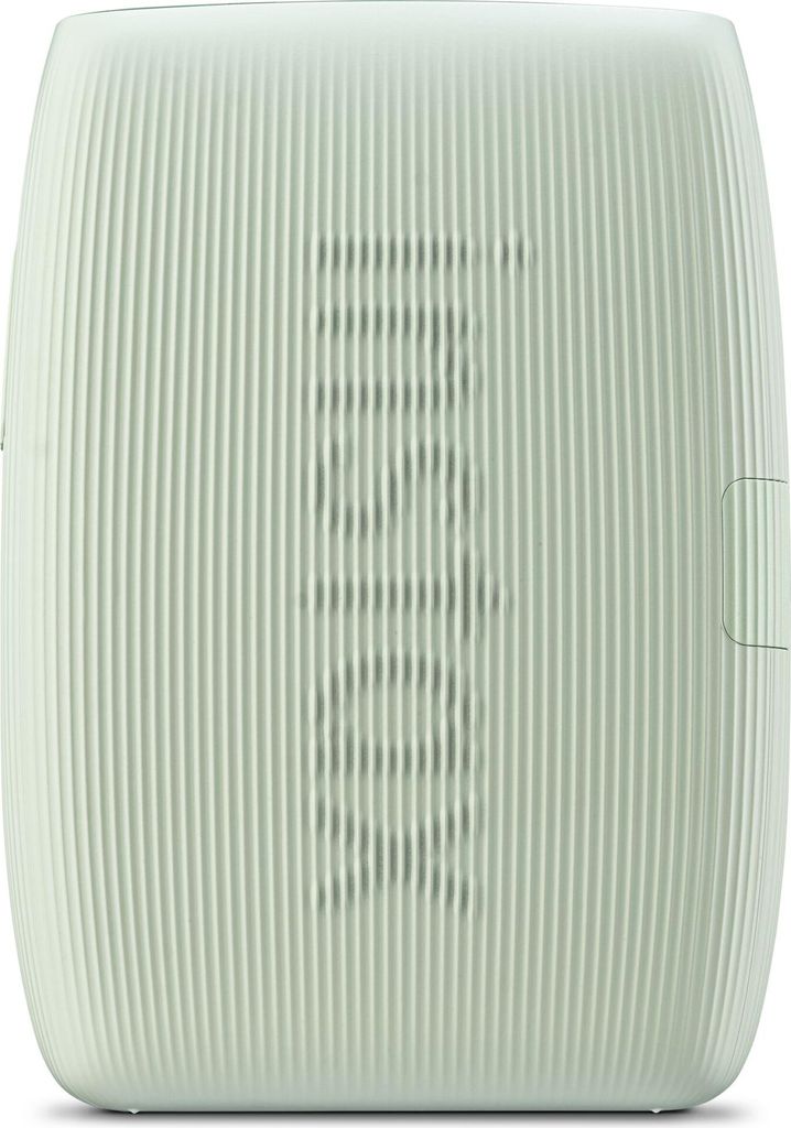 A close-up, front-facing view of a light green portable speaker with a ribbed texture and a speaker grille in the center.