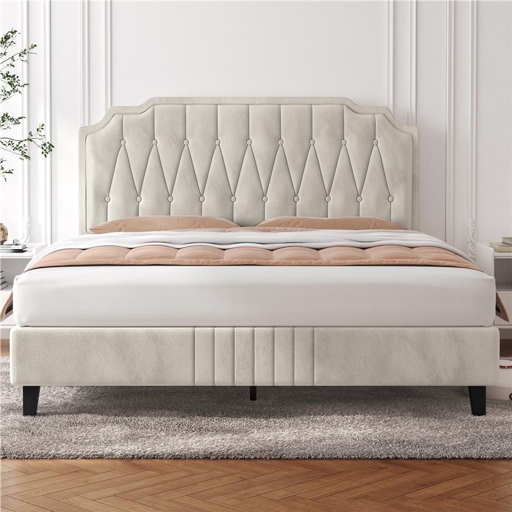 A beige upholstered bed with a tufted headboard is shown in a bedroom setting.