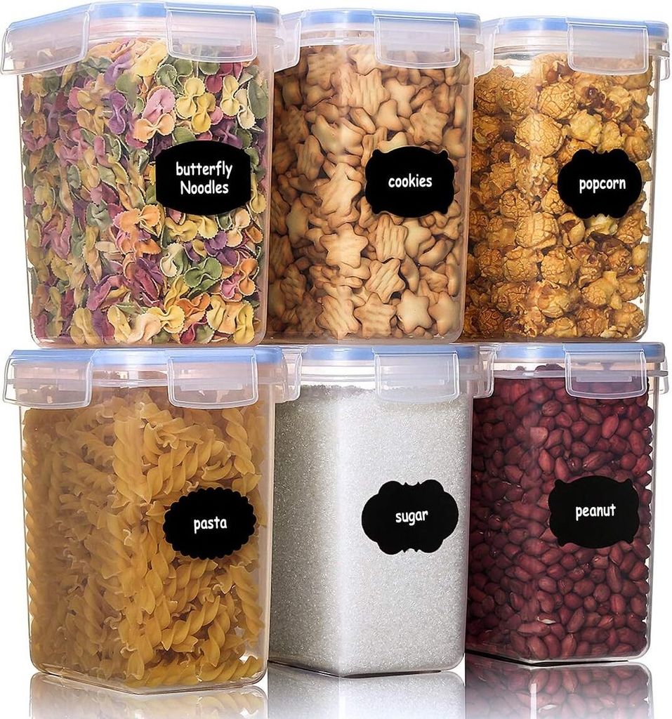 A set of six clear plastic food storage containers with blue lids, filled with various food items and labeled with black chalkboard-style labels.
