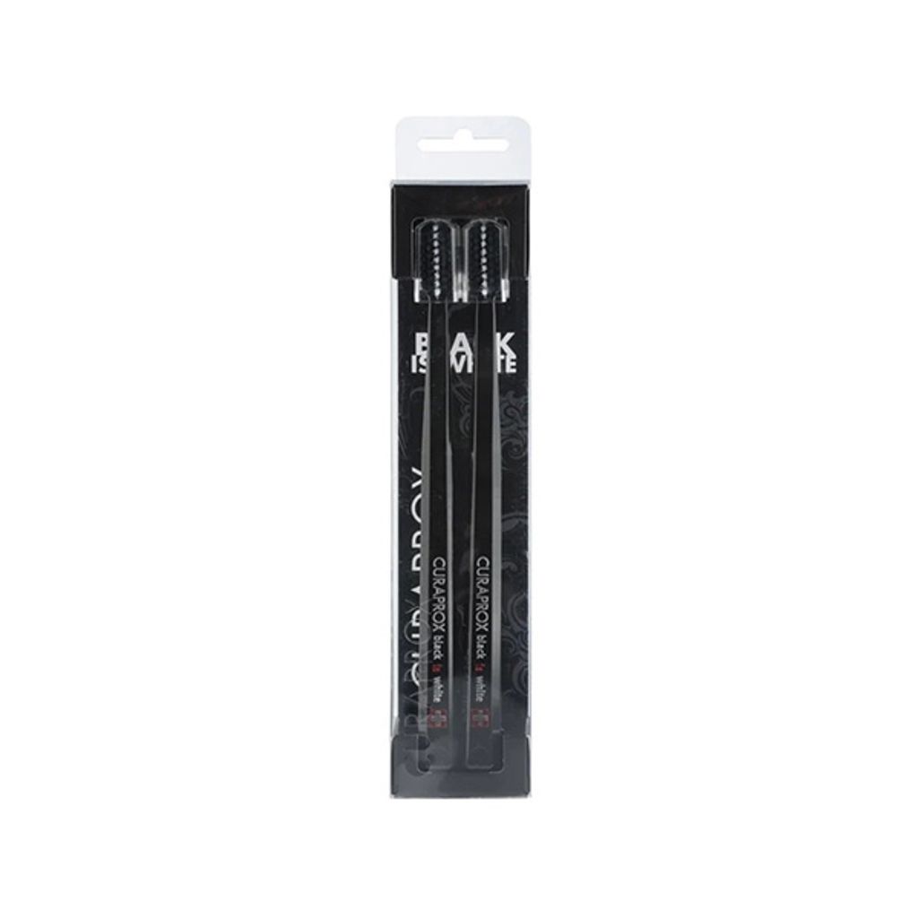 A package of three black toothbrushes is shown against a white background.