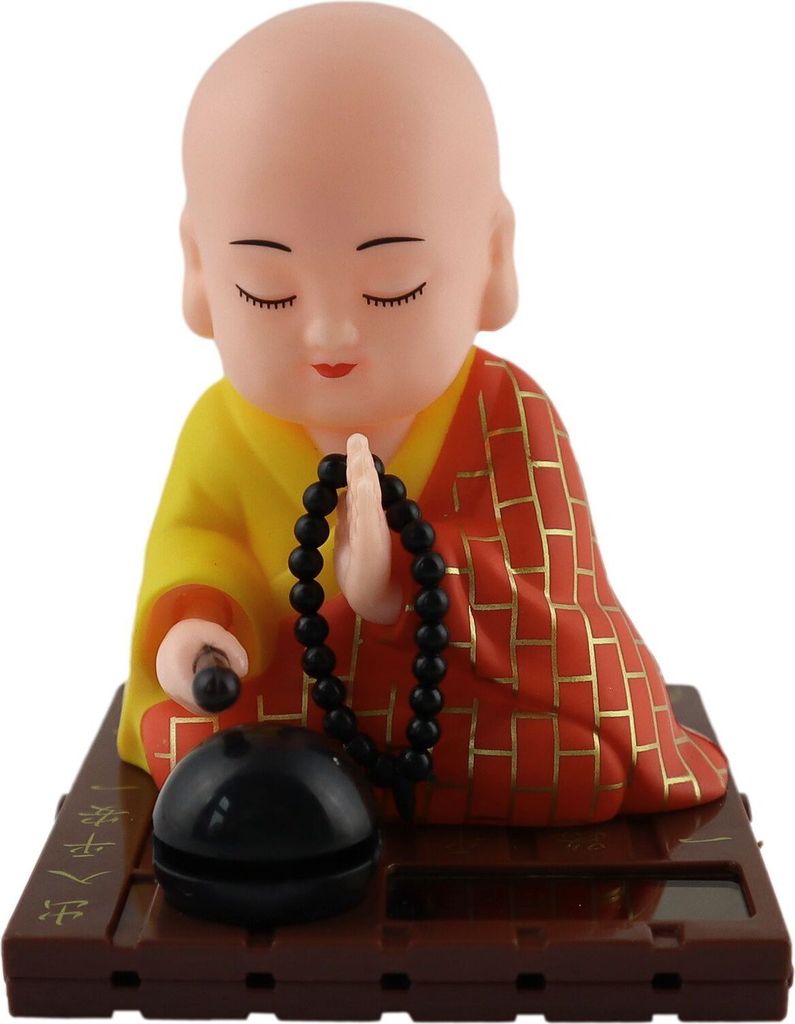 A solar-powered Wackelfigur (wobble figure) of a Buddha monk.