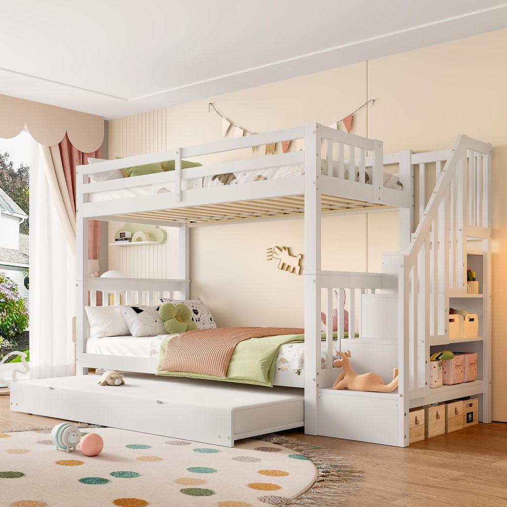 A white bunk bed with a pull-out trundle bed in a child's bedroom.