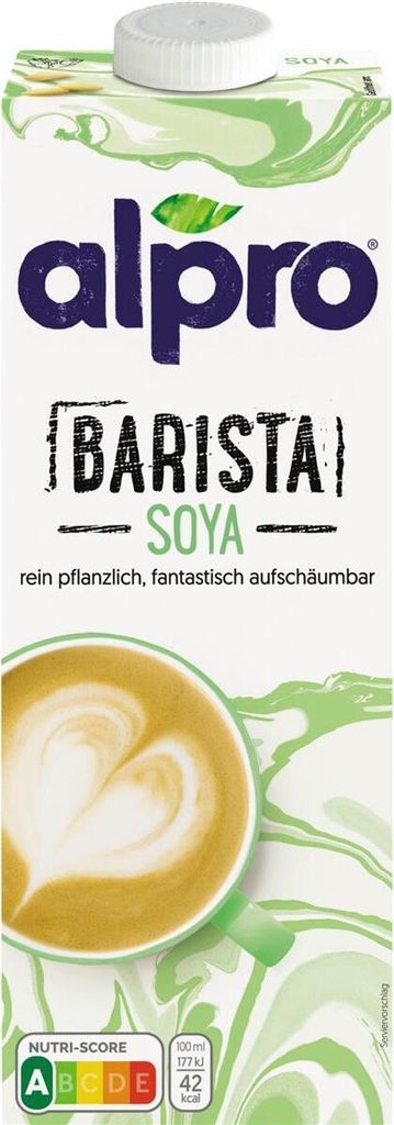 A carton of Alpro Barista Soya milk with a cup of latte art in the foreground.
