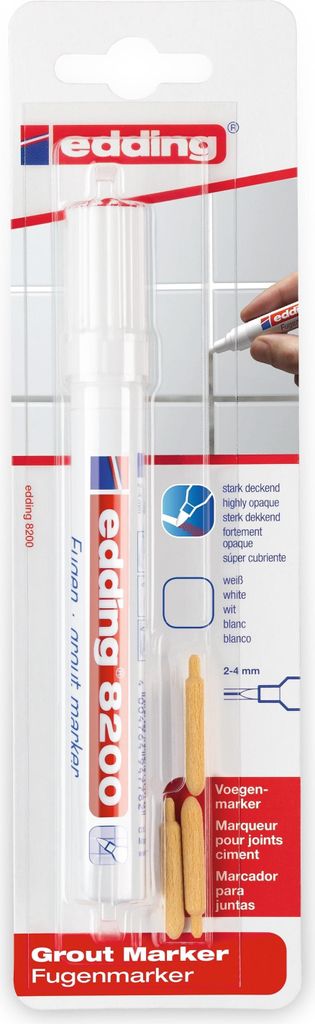 The image shows the packaging of a grout marker, with a hand using the marker on a tiled surface in the background.