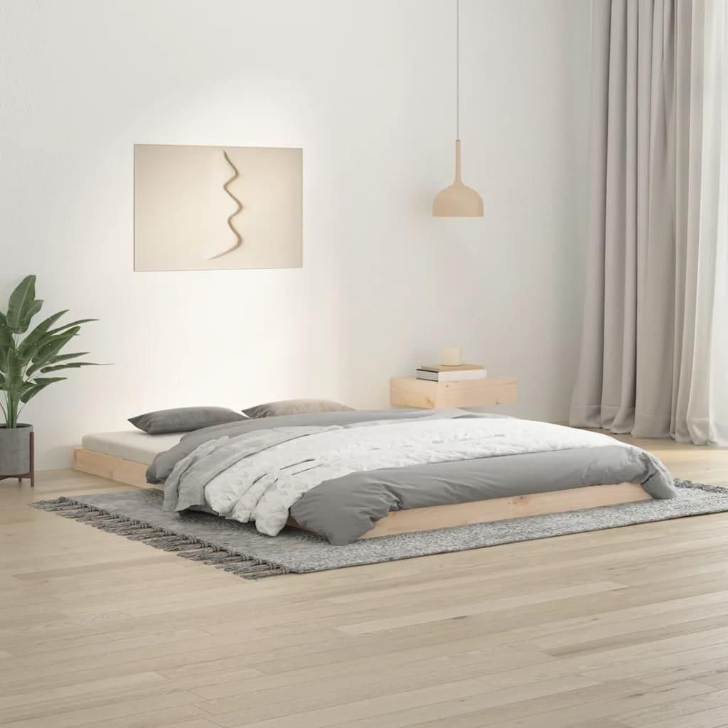 A bedroom scene with a bed, a plant, and a painting on the wall.