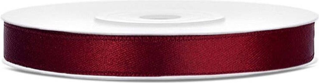 A spool of burgundy satin ribbon on a white background.