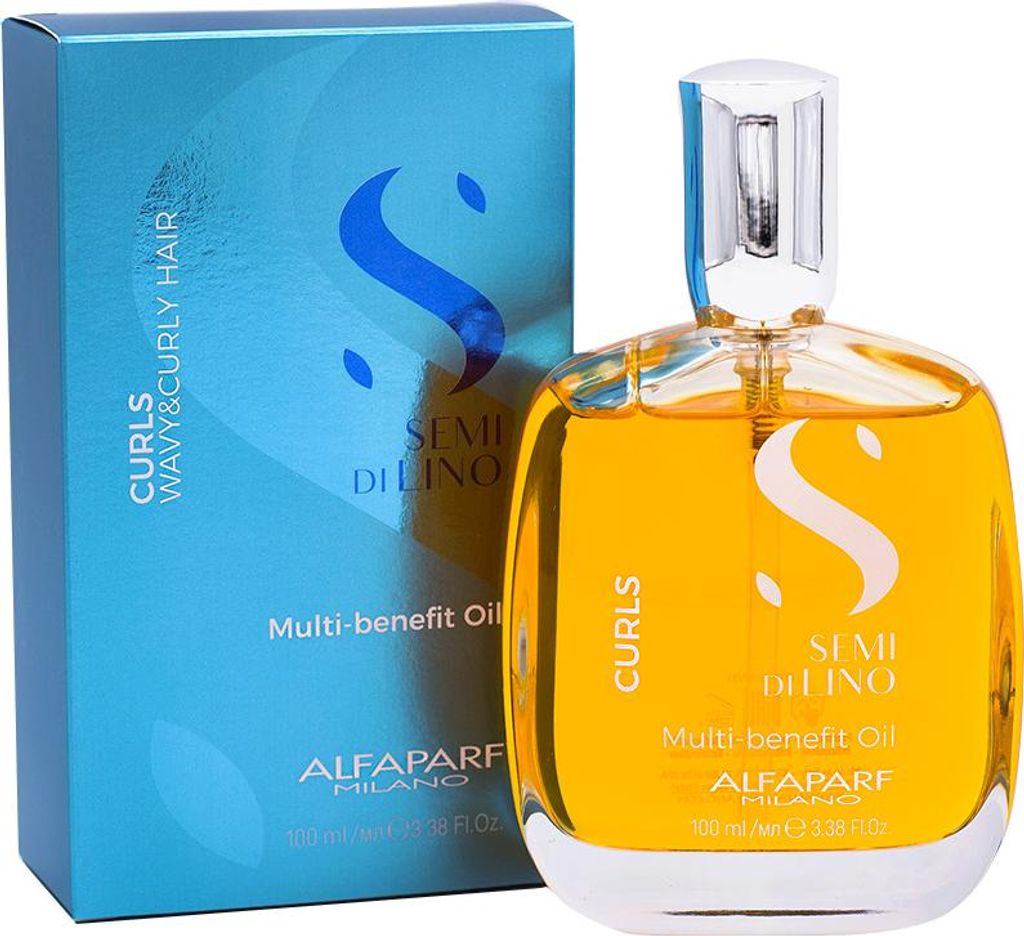 A bottle of hair oil and its packaging are displayed against a white background.