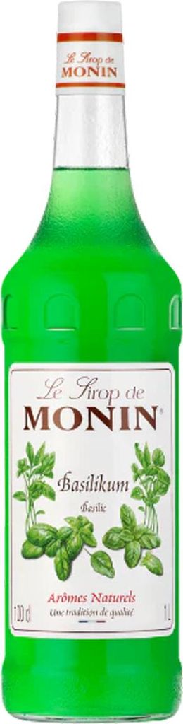 A bottle of Monin Basil syrup on a white background.