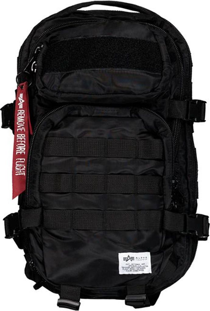 A black tactical backpack with a red "Remove Before Flight" tag.
