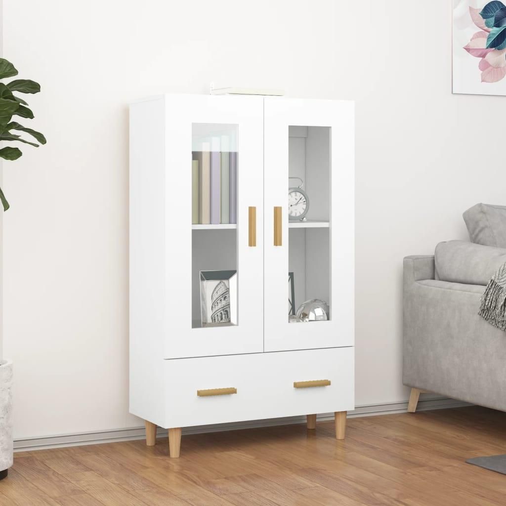 A white highboard with glass doors and drawers, displayed in a room setting with a sofa and a plant.