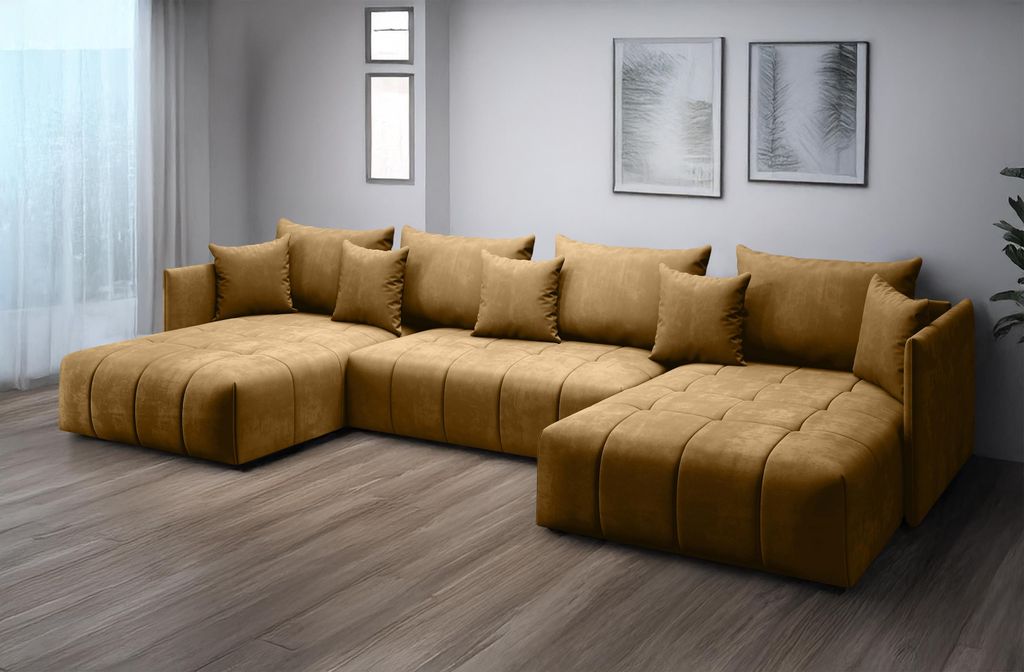 A U-shaped sectional sofa in a mustard yellow color, placed in a room with neutral walls and two framed pictures on the wall.