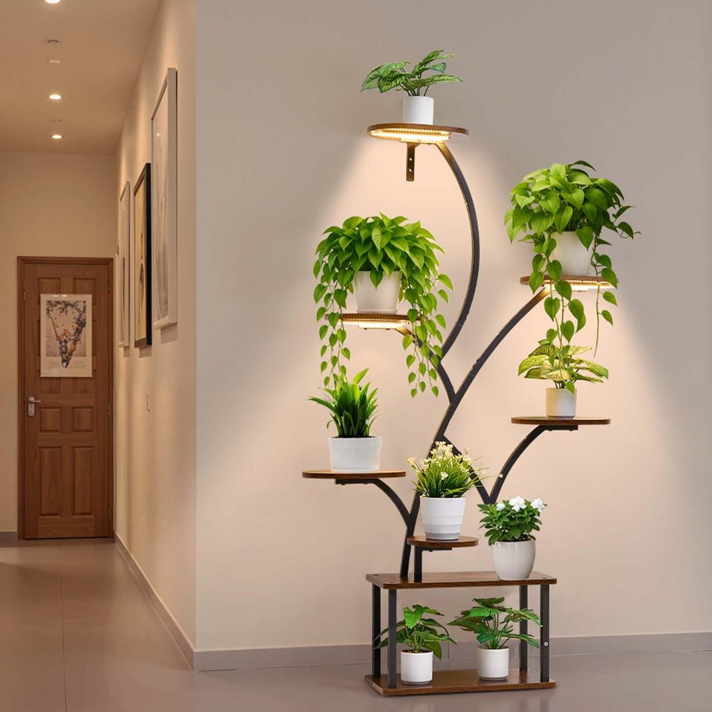 A plant stand with integrated grow lights is placed in a hallway next to a wooden door.