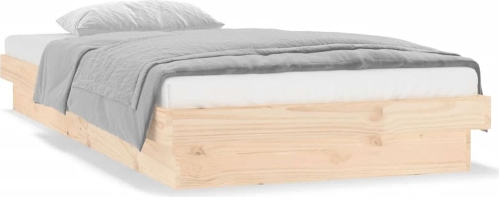 A wooden bed frame with a mattress and a grey blanket.