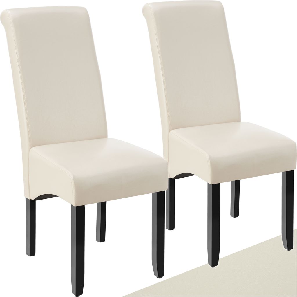Two cream-colored dining chairs with black legs are shown against a white background.
